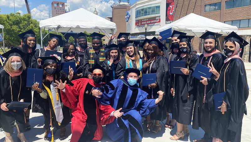 Alvin Tran and Karl Minges with graduates.